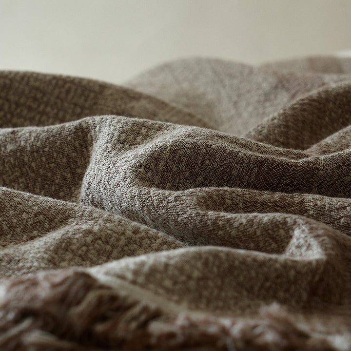 Close-up of the breathable taupe brown linen blend fabric showing its crinkle texture.