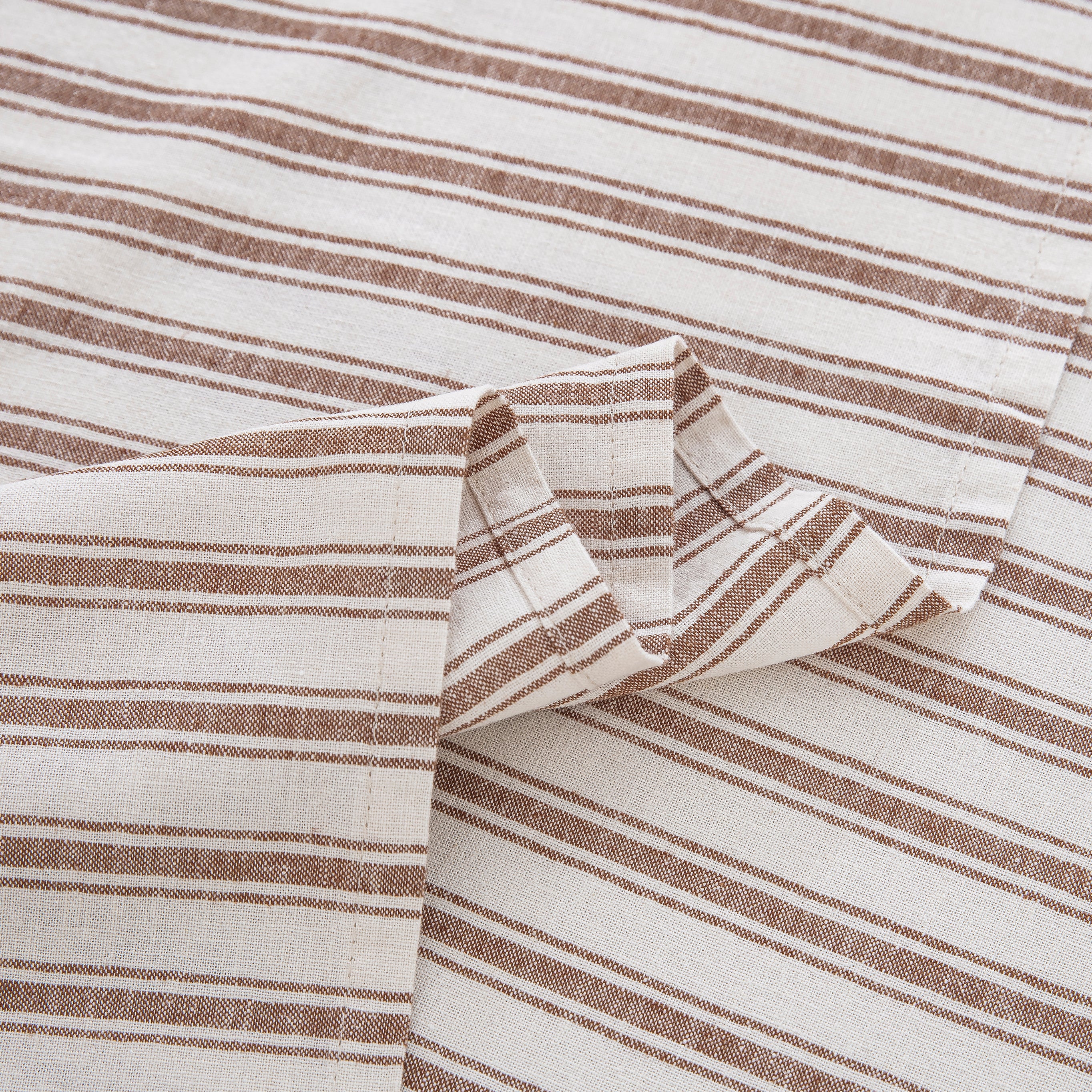 Detailed view of the beautifully draped taupe striped flat sheet highlighting the smooth softness and rustic texture - DAUAOTO