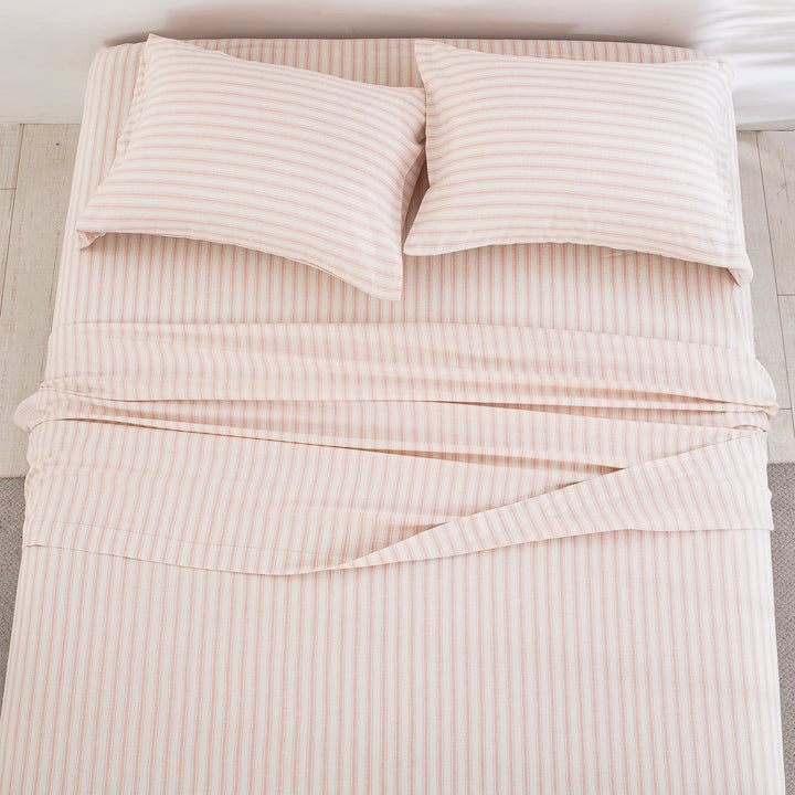 Top-down view of the airy elegance and finely tailored blush pink stripe pattern of the linen cotton bed sheets - DAUAOTO