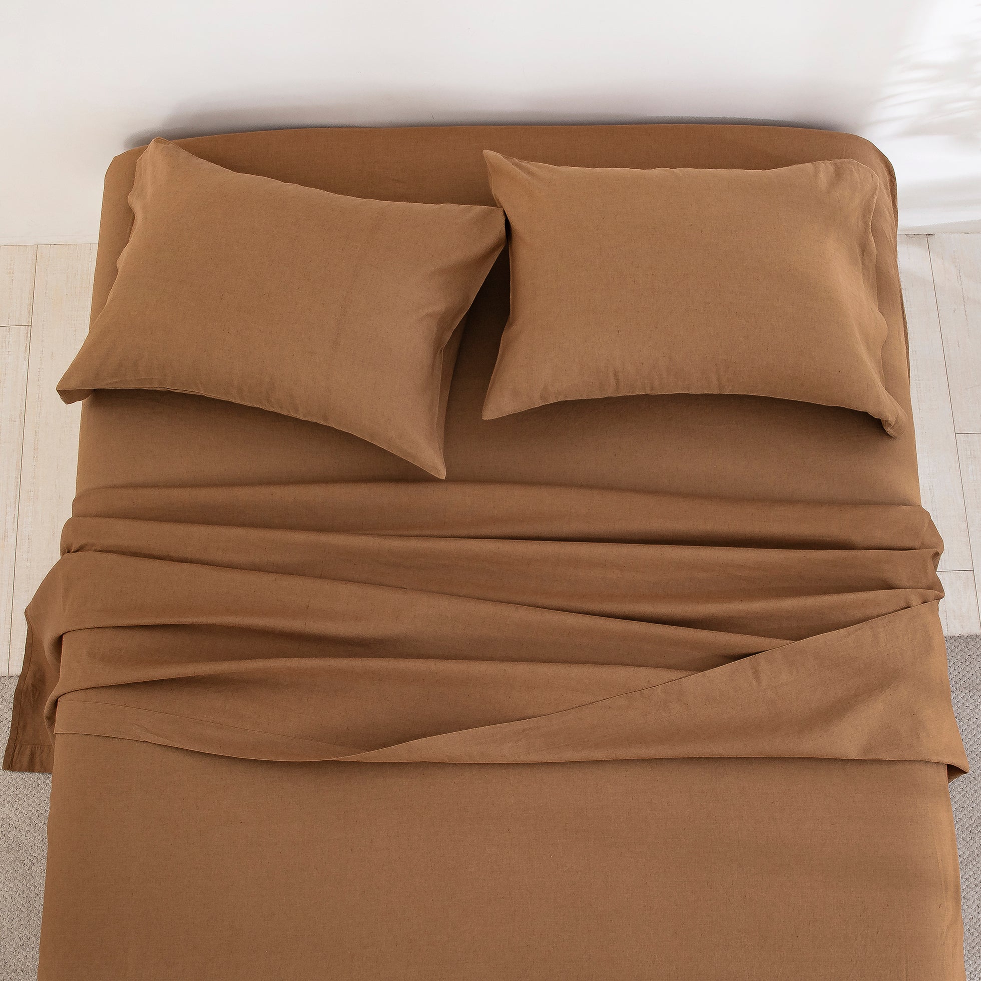Top-down view of the deeply comforting and earthy elegance of the cognac brown linen cotton bed sheets - DAUAOTO