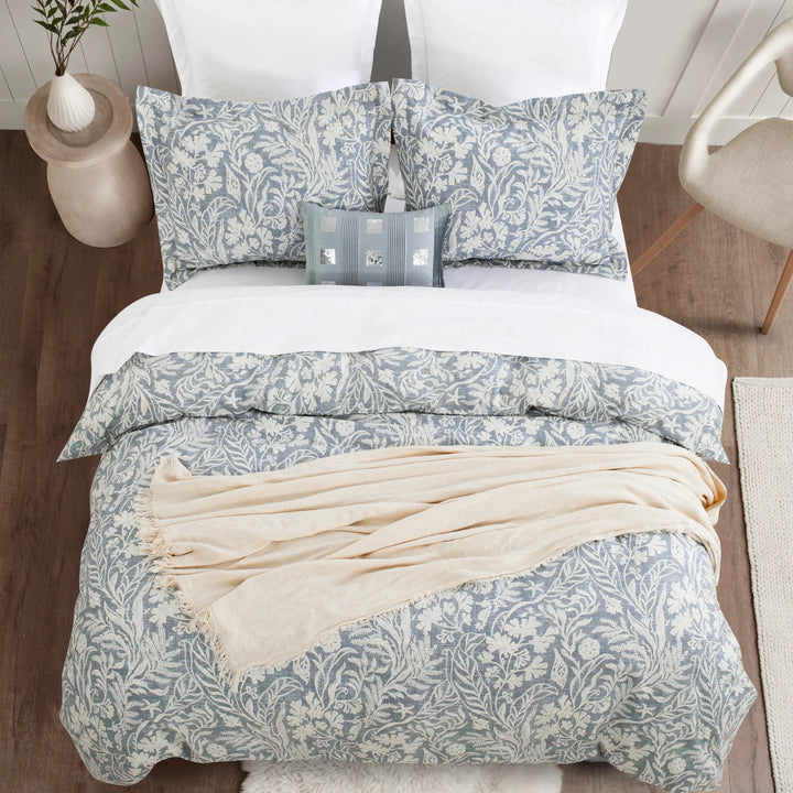 Top-down view of the serene and reversible dusty blue botanical print pure cotton bedding set - DAUAOTO