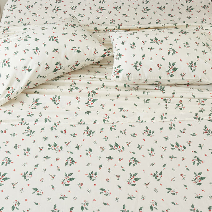 Top-down view of the festive holly berry print cotton sheets bringing joyful holiday cheer to your sleep sanctuary - DAUAOTO