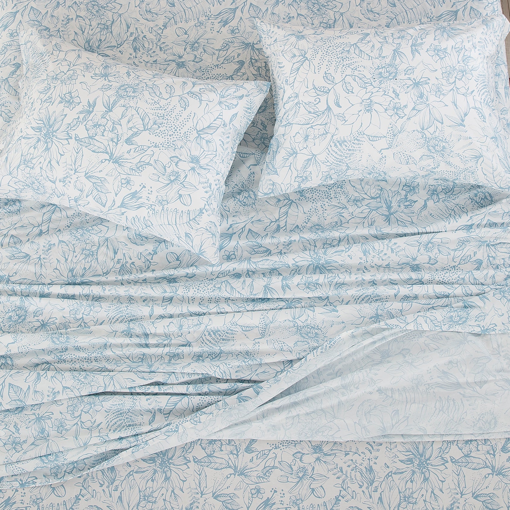 Top-down view of the serene light blue floral vine pattern on a soft off-white ground - DAUAOTO