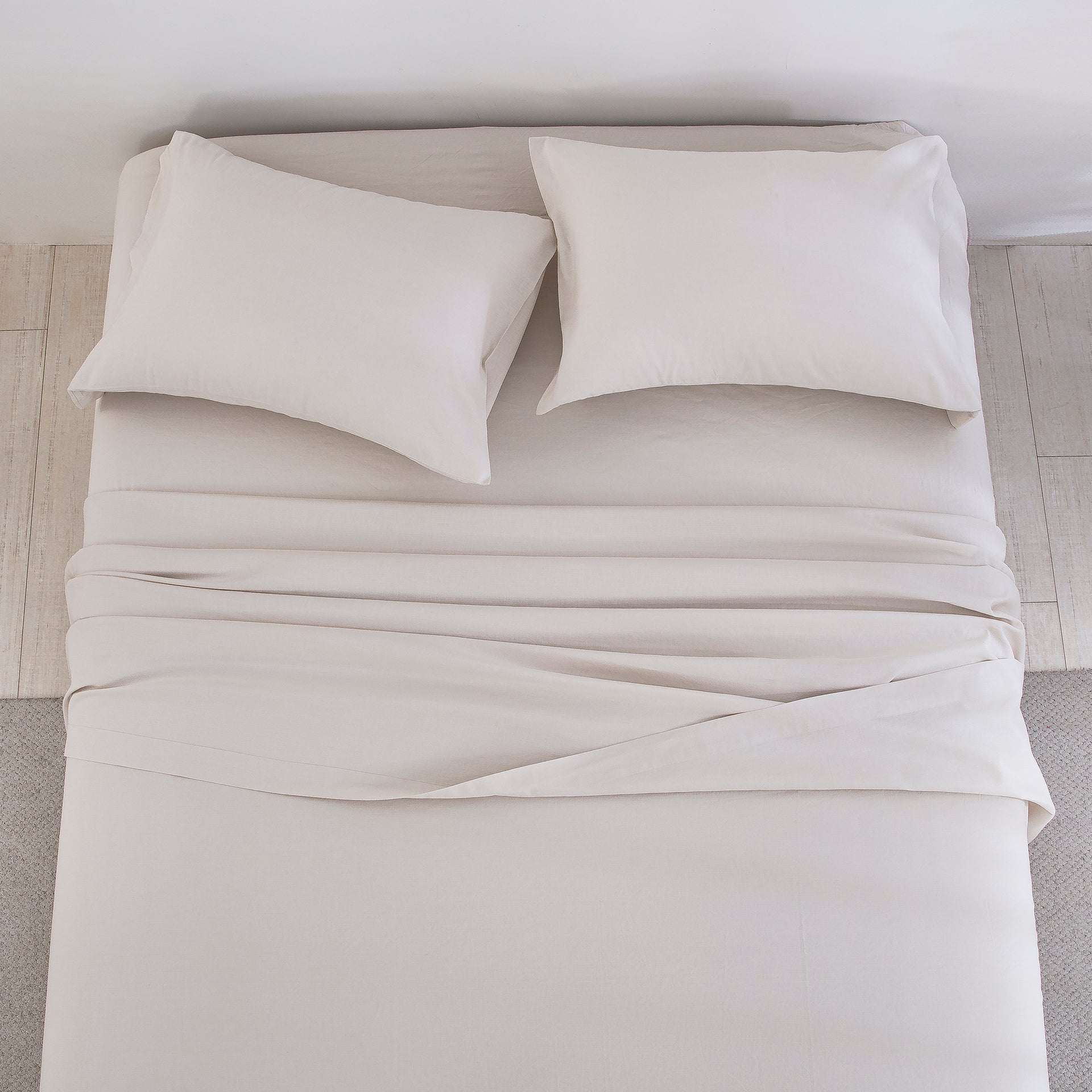 Top-down view of the effortless organic elegance and beautiful natural texture of oatmeal linen cotton bed sheets - DAUAOTO