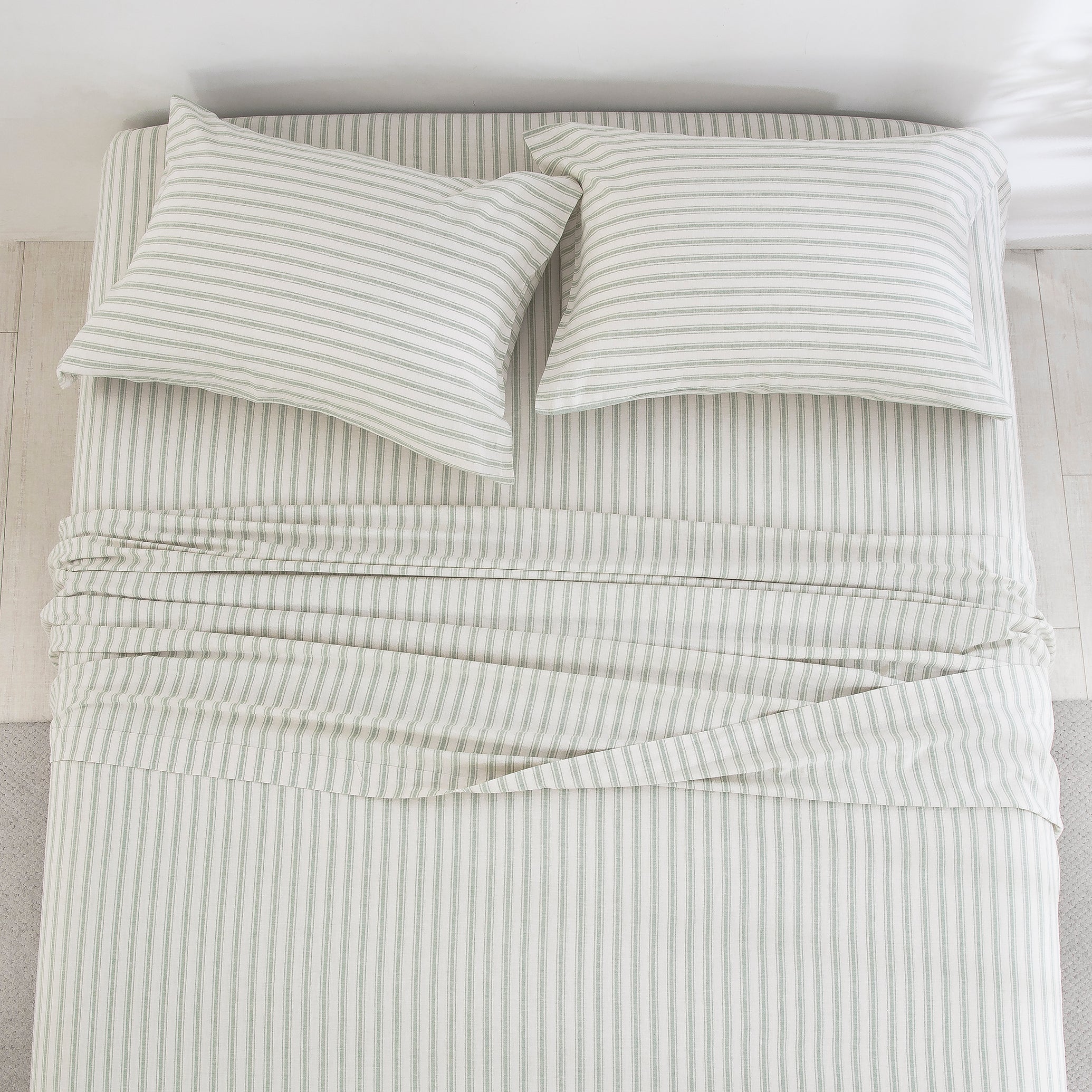 Top-down view of the calming outdoor-inspired serenity and finely tailored ticking stripe pattern of the linen cotton bed sheets - DAUAOTO