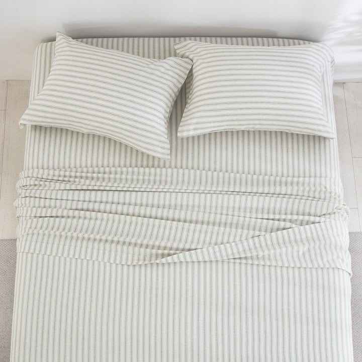 Top-down view of the calming outdoor-inspired serenity and finely tailored ticking stripe pattern of the linen cotton bed sheets - DAUAOTO