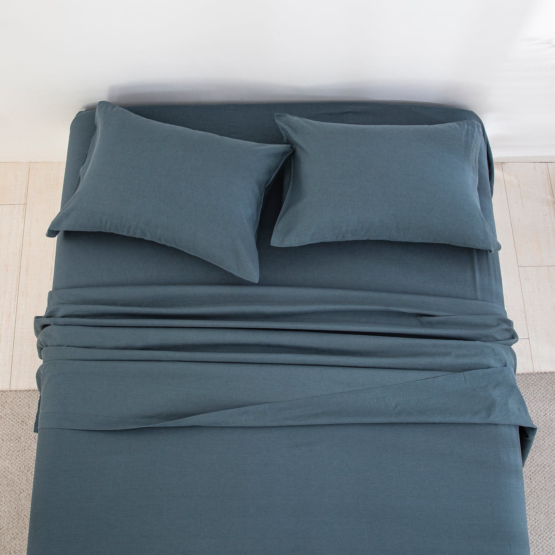 Top-down view of the deep calming blue-grey tone and naturally beautifully textured finish of the linen cotton bed sheets - DAUAOTO