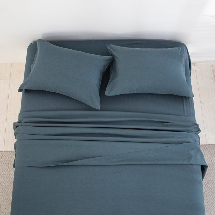 Top-down view of the deep calming blue-grey tone and naturally beautifully textured finish of the linen cotton bed sheets - DAUAOTO