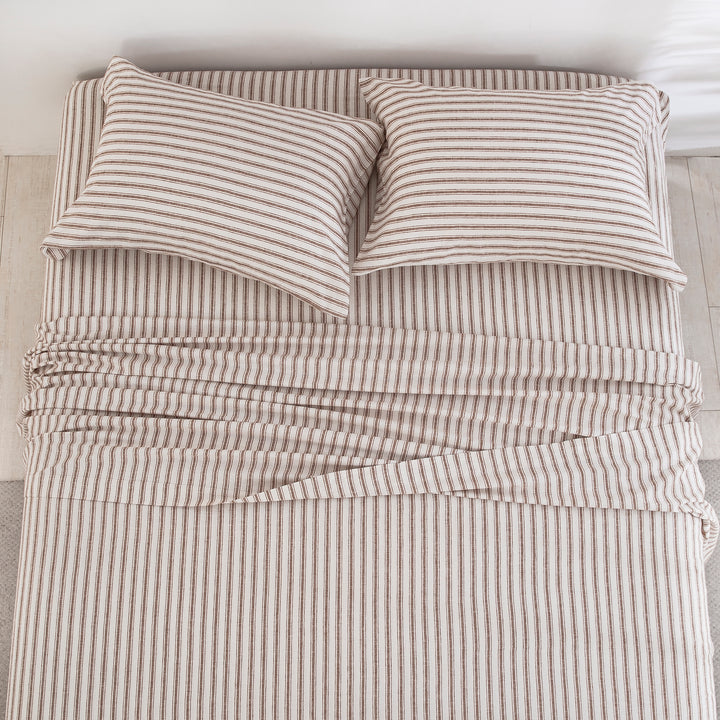 Top-down view of the understated elegance and finely tailored taupe ticking stripe pattern of the linen cotton bed sheets - DAUAOTO