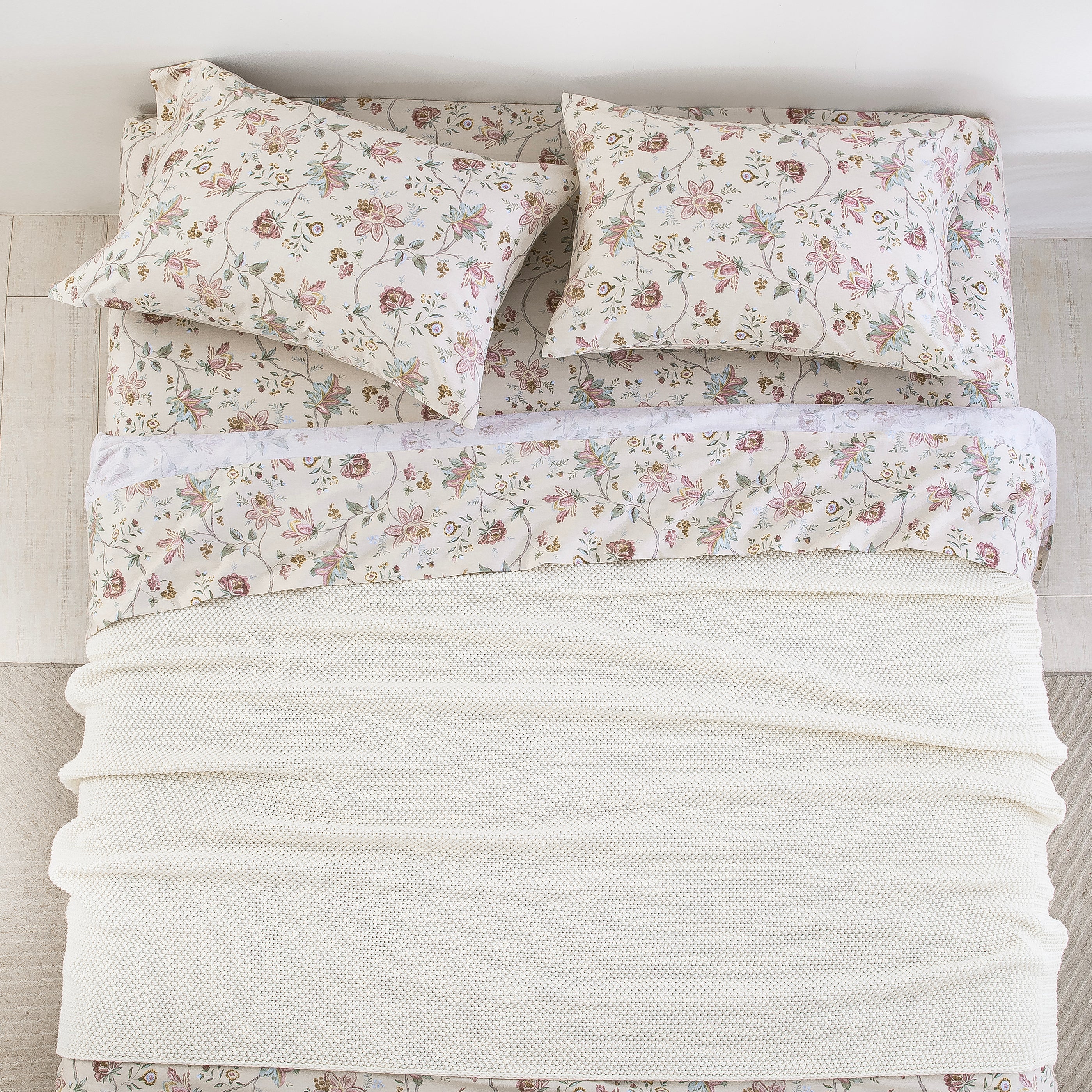 Top-down bird's-eye view of a perfectly made bed featuring the DAUAOTO antique rose floral sheet set layered with a white blanket.