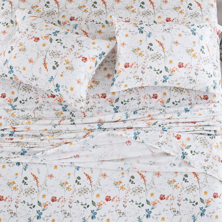 Top-down view of the sleep sanctuary styled with the vibrant watercolor wildflower print pure cotton bed sheets - DAUAOTO