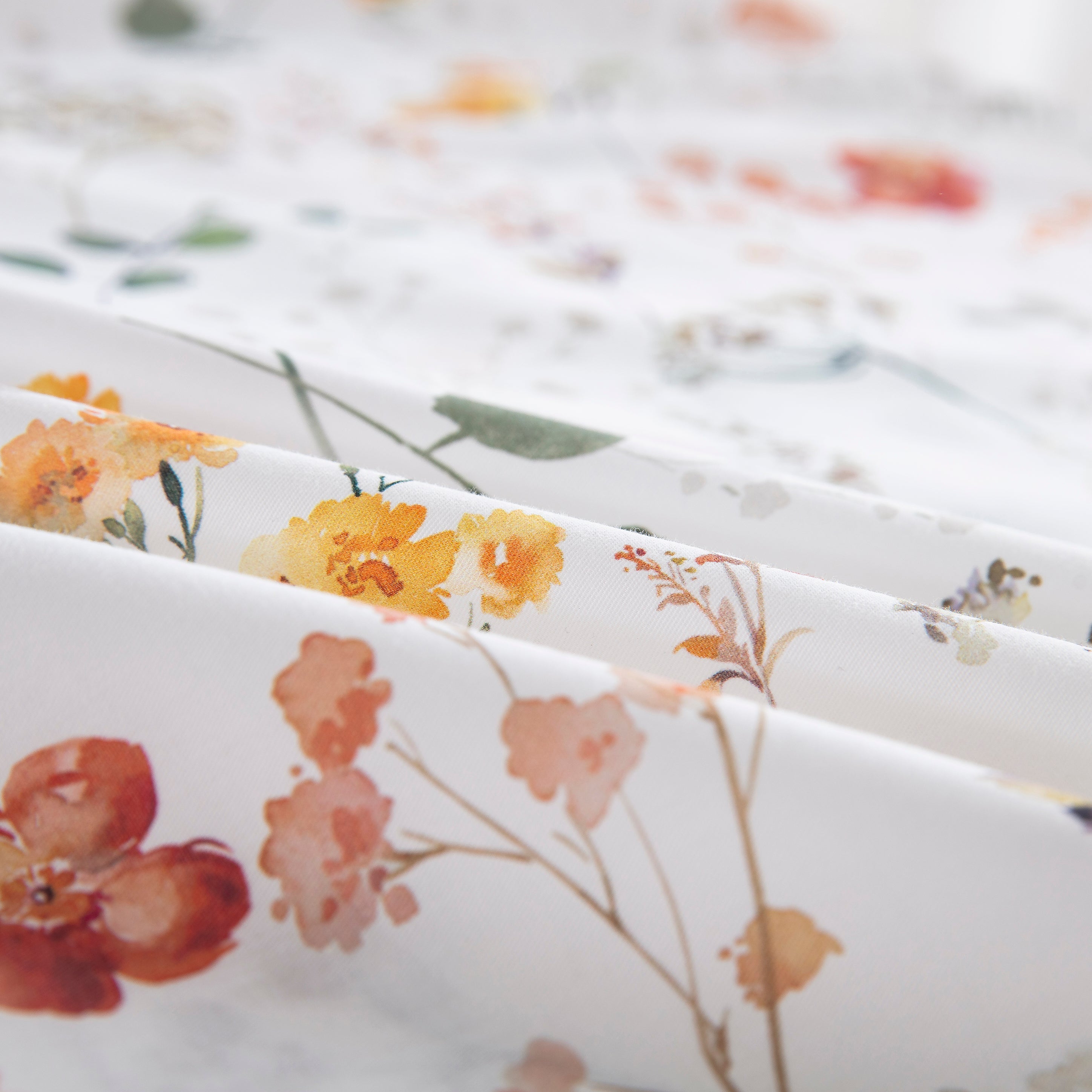 Close-up of the ultra-soft pure cotton fabric showing delicate wildflowers and winding foliage in vibrant colors - DAUAOTO