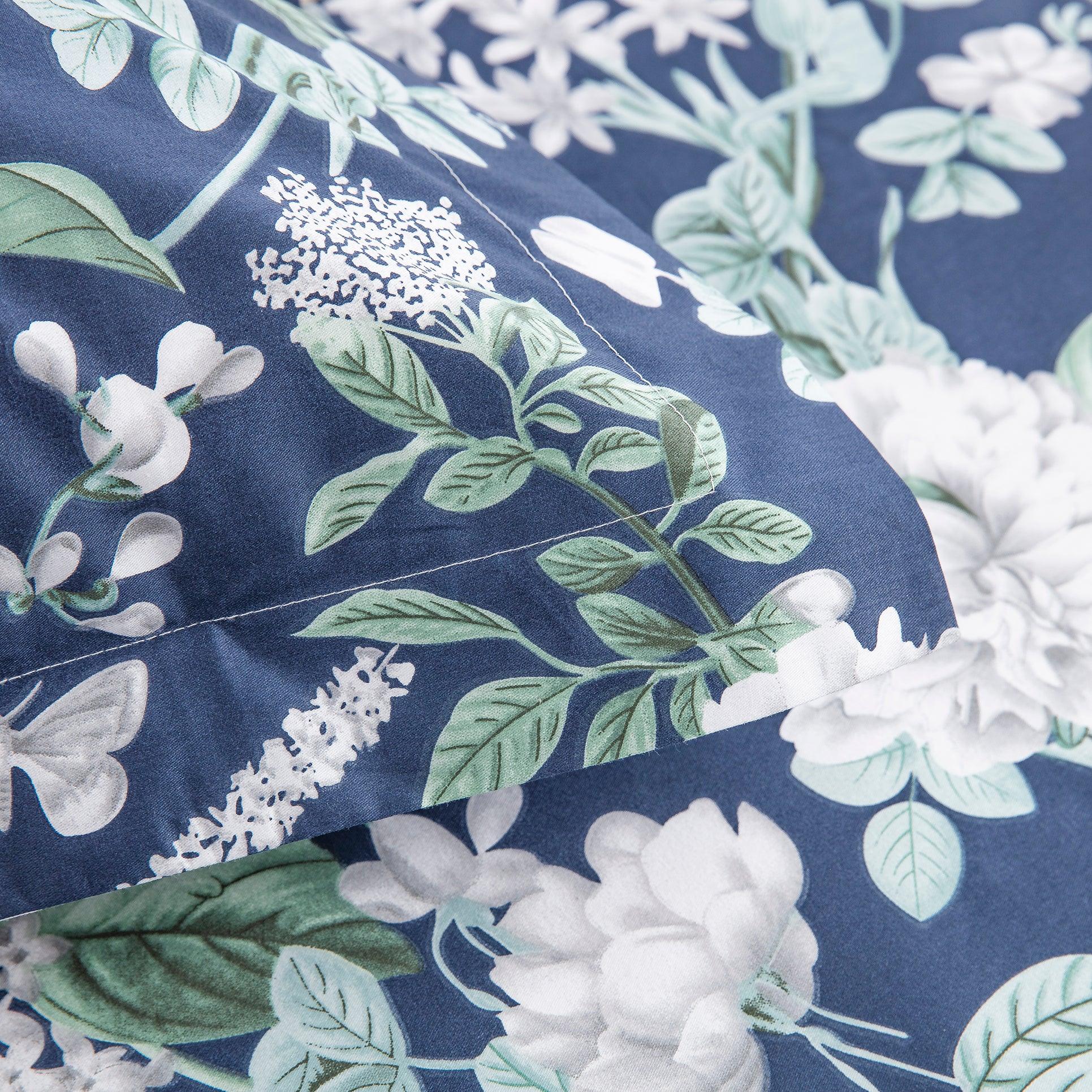 Detailed view of delicate green leaves and white florals pattern on premium cotton bedding - DAUAOTO