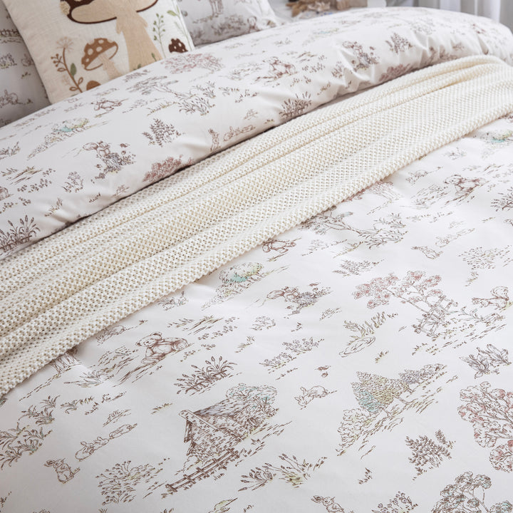 DAUAOTO woodland print lightweight cotton duvet cover layered elegantly with a cream knit throw blanket.
