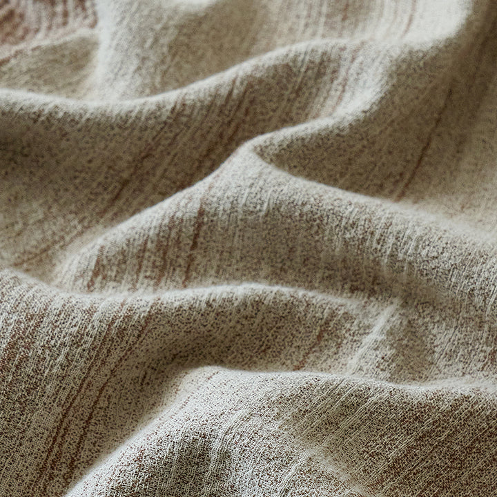 Close-up of the breathable warm sand linen blend fabric showing its natural crinkle texture.