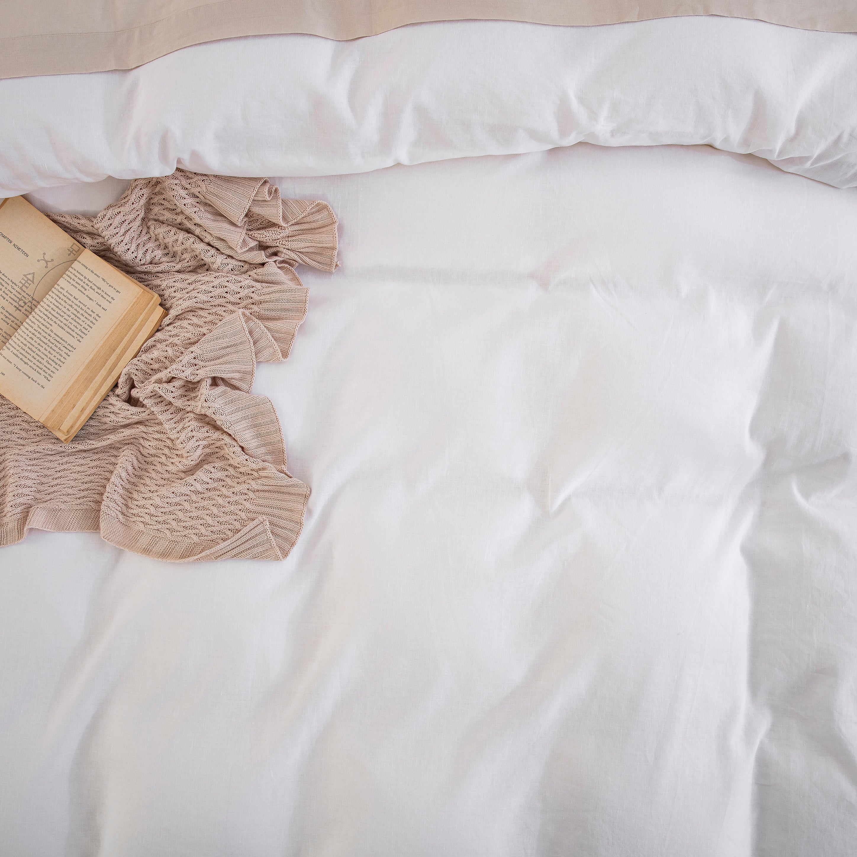 Detailed view of the breathable white linen cotton duvet cover layered over a textured checkered insert for a cozy aesthetic - DAUAOTO