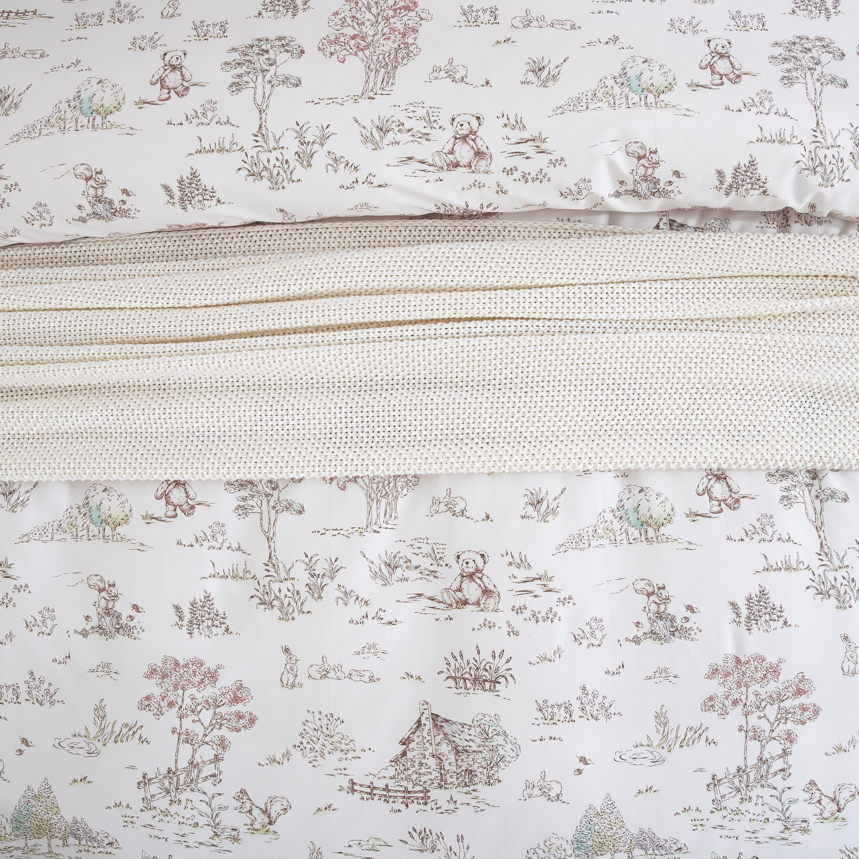 Close-up showing the cozy layered styling of the DAUAOTO vintage woodland cotton duvet cover and knit blanket.