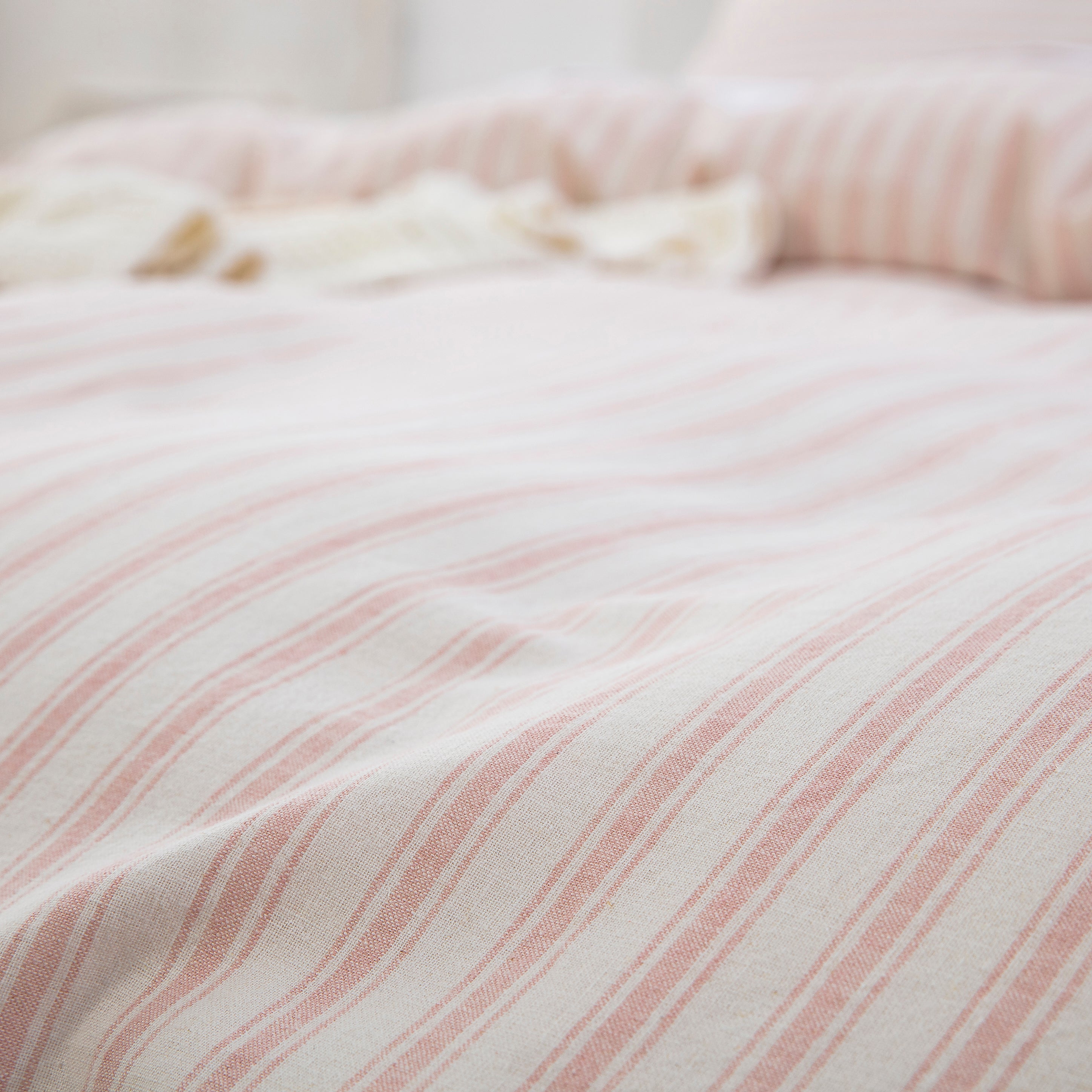 Close-up of the yarn-dyed blush pink stripe pattern showing rich color depth and tactile texture - DAUAOTO